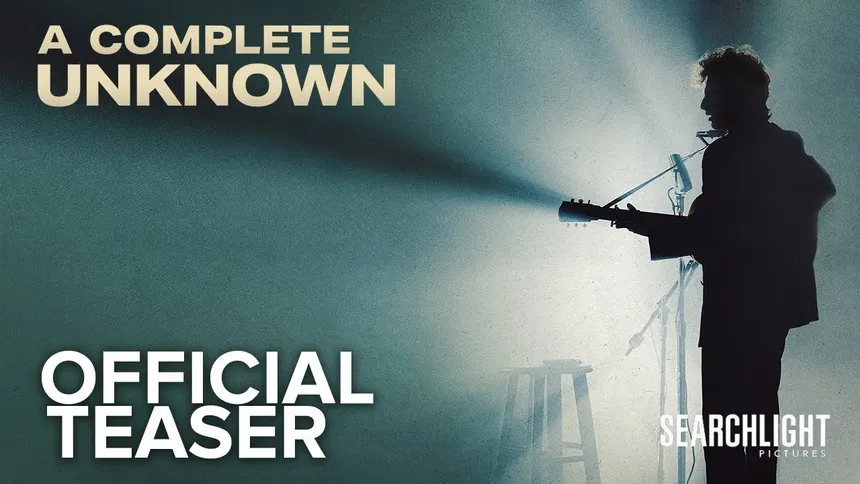 A silhouetted figure carrying an acoustic guitar beneath the title A Complete Unknown