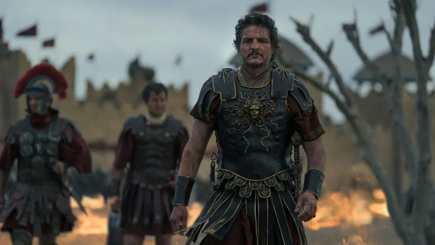 A Roman general in ornate Medusa-emblazoned armor leading soldiers before a burning city
