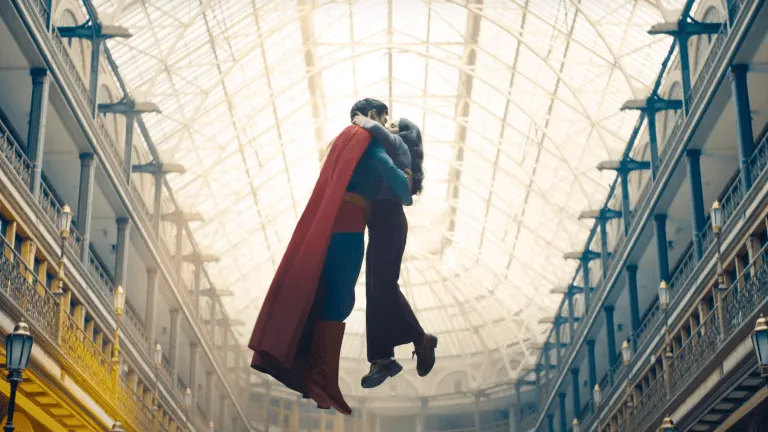 Superman and Lois Lane embracing in mid-air beneath the glass roof of a grand arcade in a still from the film